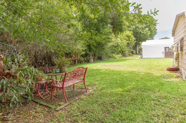 a view of a house with a yard and sitting area