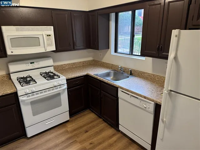 a kitchen with a stove microwave and refrigerator