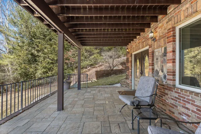 a kitchen with stainless steel appliances granite countertop a refrigerator a stove top oven a dining table and chairs