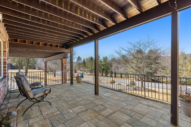 a kitchen with stainless steel appliances granite countertop table chairs and a refrigerator