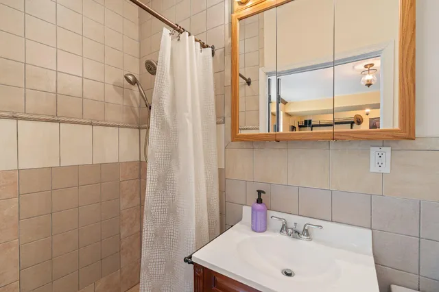 a spacious bedroom with a bed and a refrigerator