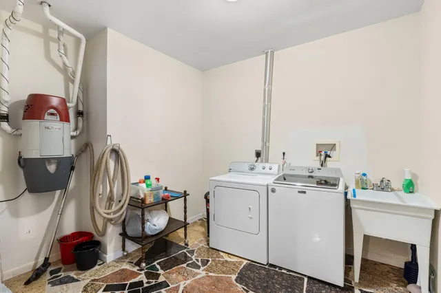 a bathroom with a granite countertop sink mirror and bathtub