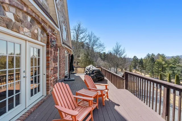 a view of balcony with furniture and trees in the background