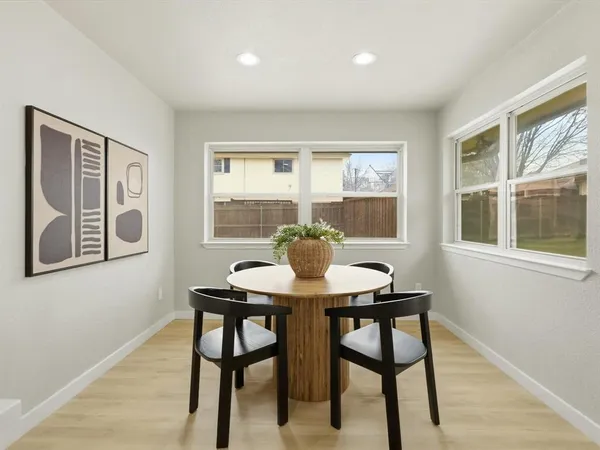 a kitchen with a dining table and chairs
