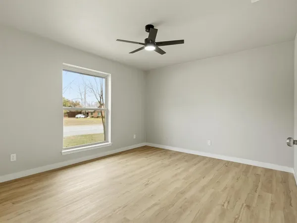 a bedroom with a bed lamp and a window