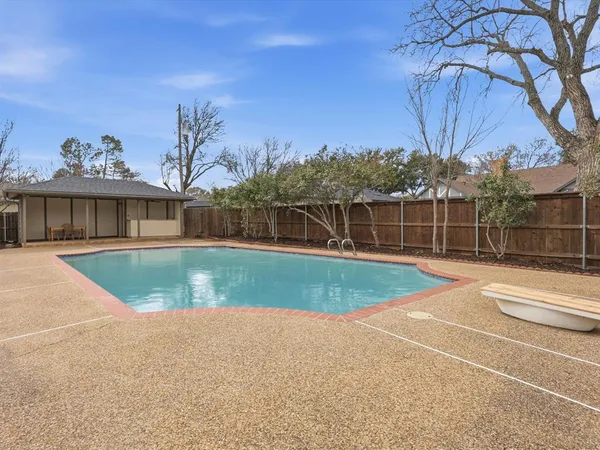 a view of a house with pool and chairs