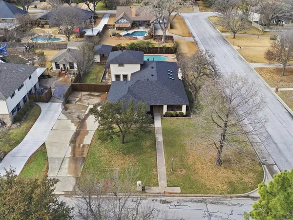 an aerial view of a house with a swimming pool