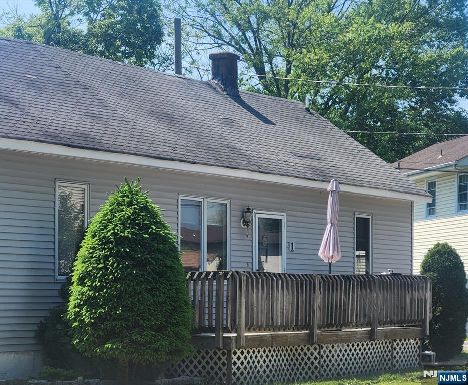 1 Cedar Lane Paramus, NJ 07652 - Photo 2 of 13 a view of a house with a small yard plants and large tree