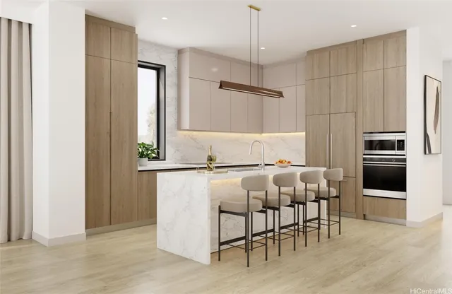 a kitchen with stainless steel appliances kitchen island granite countertop a refrigerator and a stove top oven