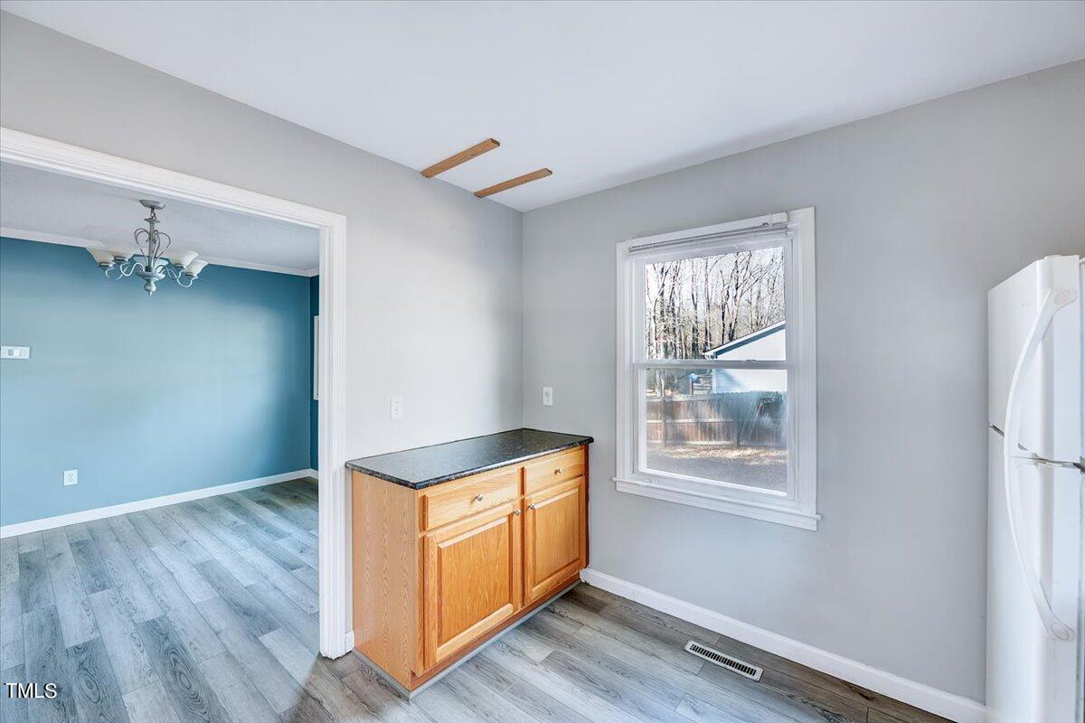 1831 Milan Street Durham, NC 27704 - Photo 12 of 38 a room with window and a wooden floor
