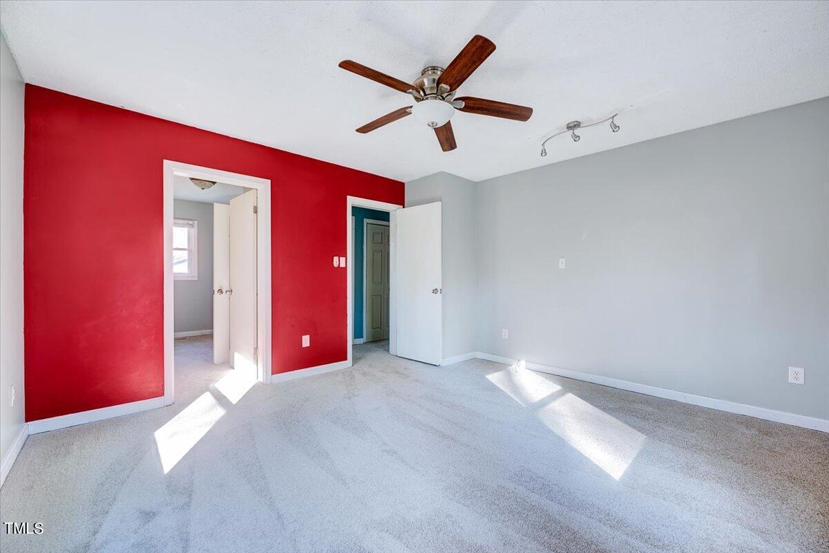 1831 Milan Street Durham, NC 27704 - Photo 14 of 38 a view of an empty room with a ceiling fan