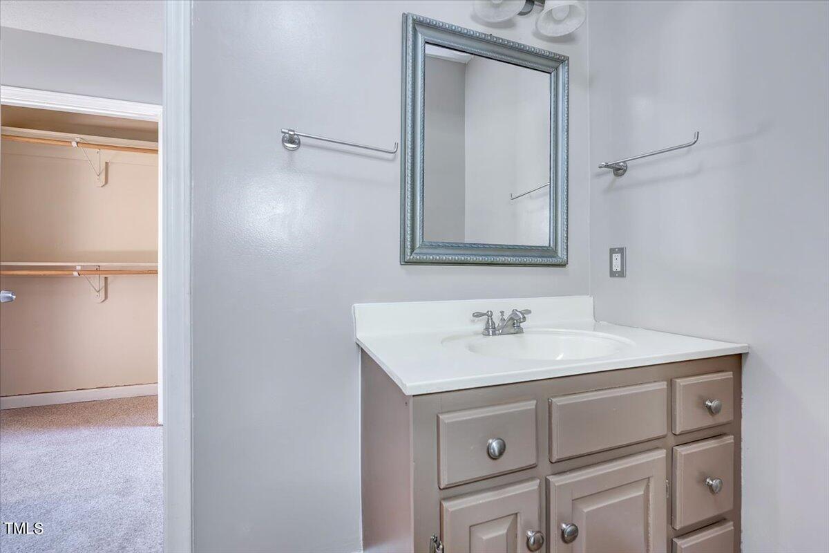 1831 Milan Street Durham, NC 27704 - Photo 18 of 38 a bathroom with a sink vanity and a mirror