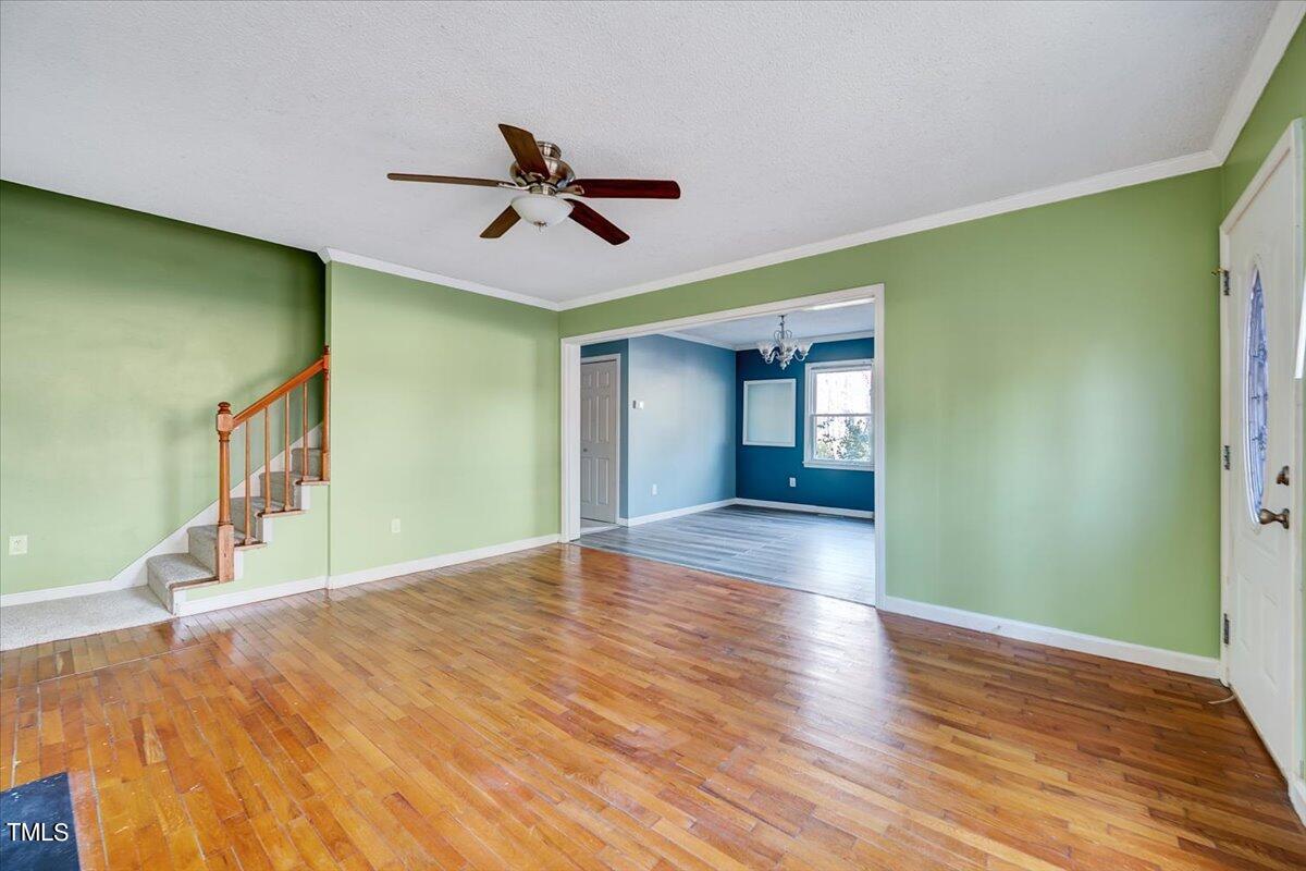 1831 Milan Street Durham, NC 27704 - Photo 4 of 38 a view of empty room with wooden floor and fan