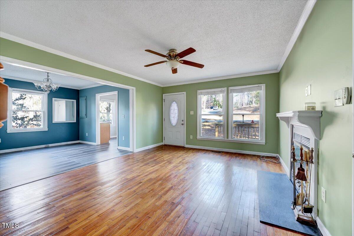 1831 Milan Street Durham, NC 27704 - Photo 5 of 38 a view of a livingroom with hardwood floor and a ceiling fan