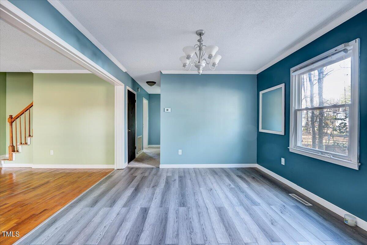 1831 Milan Street Durham, NC 27704 - Photo 7 of 38 wooden floor in an empty room with a window