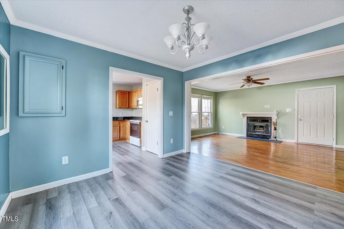1831 Milan Street Durham, NC 27704 - Photo 8 of 38 a view of an empty room with wooden floor and a window