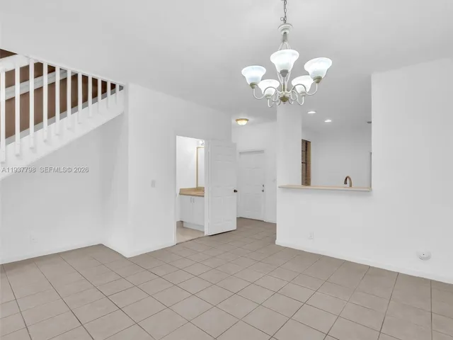 a view of a hallway with chandelier