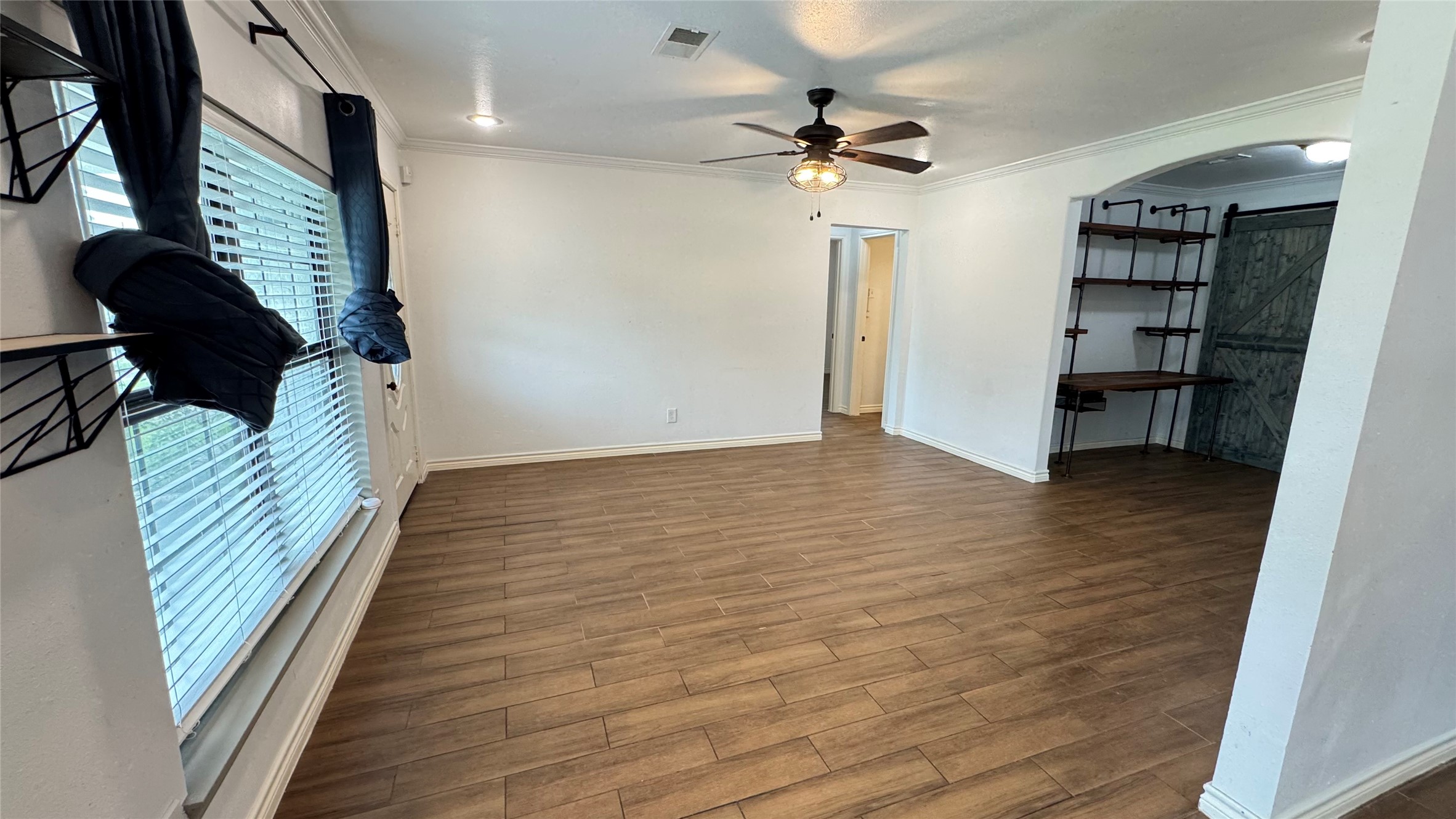 221 Hyta Street Houston, TX 77018 - Photo 6 of 35 wooden floor in an empty room with a window