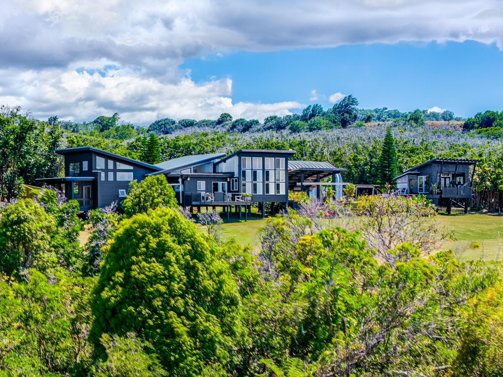 a view of a house with a yard and sitting area