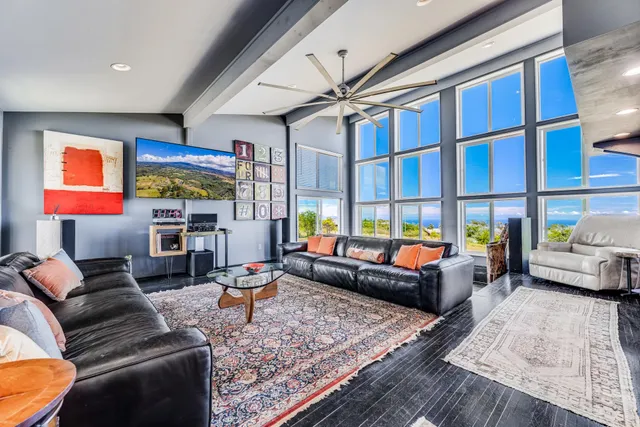 a living room with furniture a rug and a window