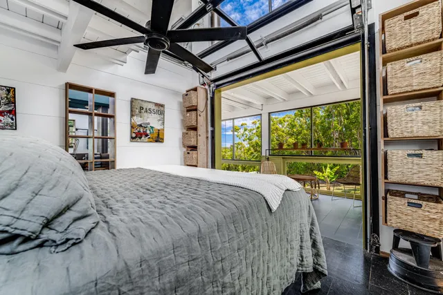 a bed sitting in a bedroom next to a window