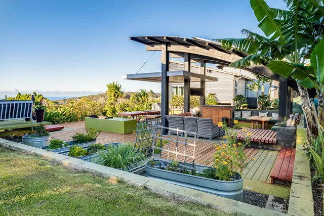 a view of a patio with couches table and chairs and potted plants