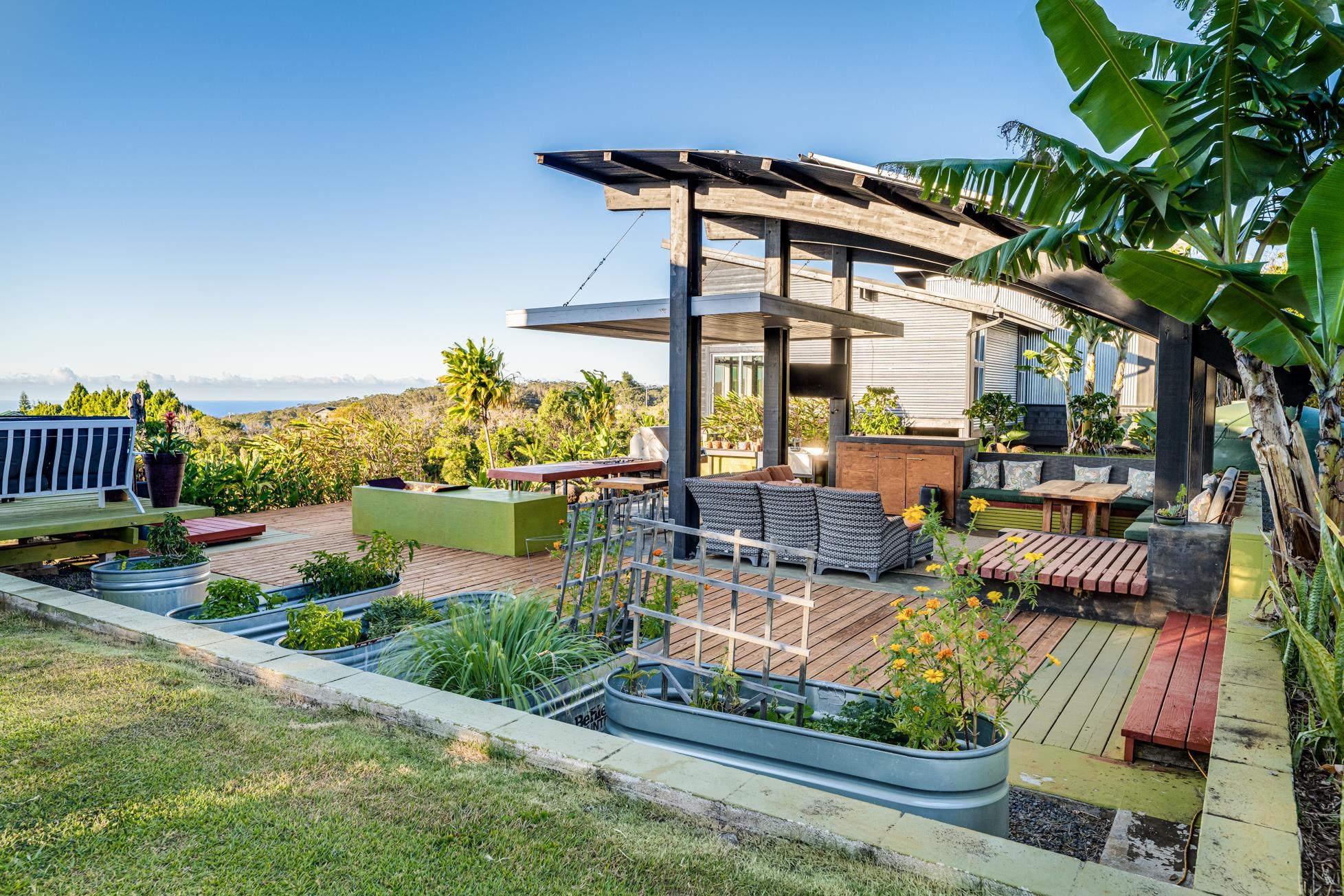 796 Awalau Road Haiku, HI 96708 - Photo 25 of 50 a view of a patio with couches table and chairs and potted plants