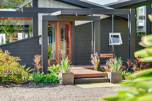 a front view of a house with a garden