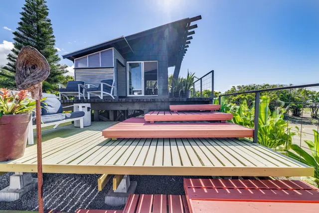 a view of a patio with table and chairs with wooden floor and plants
