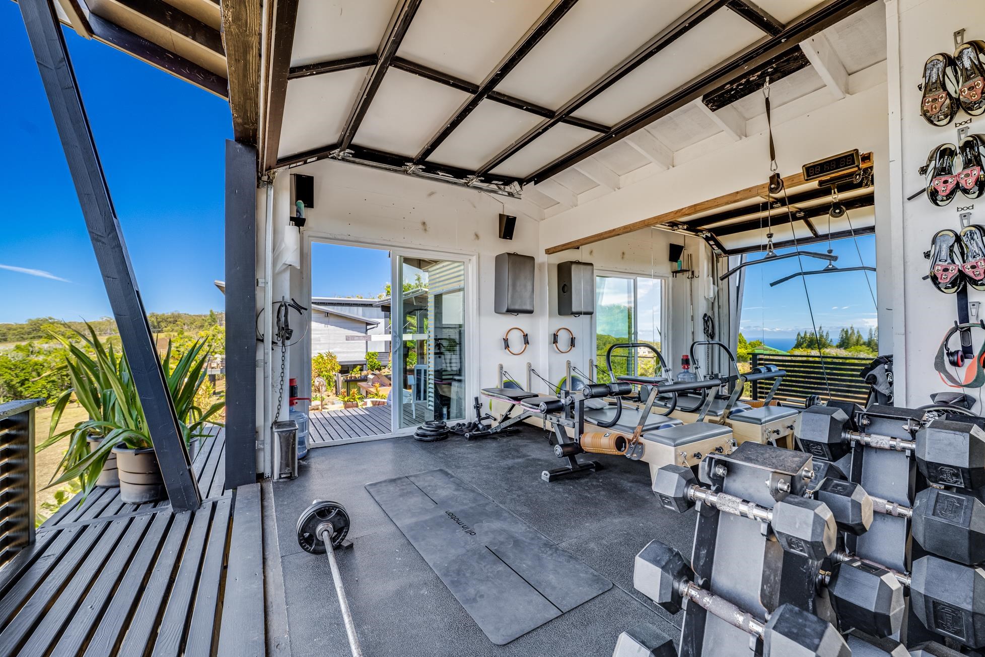 796 Awalau Road Haiku, HI 96708 - Photo 33 of 50 a view of a patio with table and chairs with wooden floor and plants