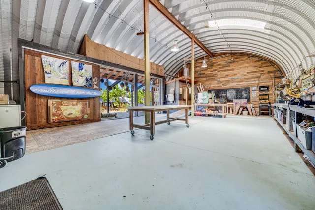 a bedroom with a bed and large windows