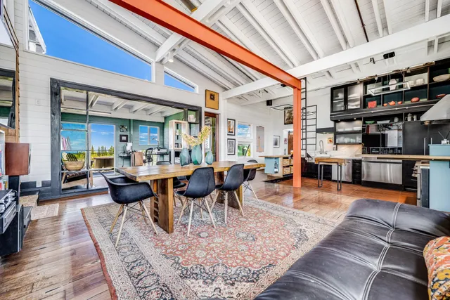 a living room with lots of furniture and a book shelf