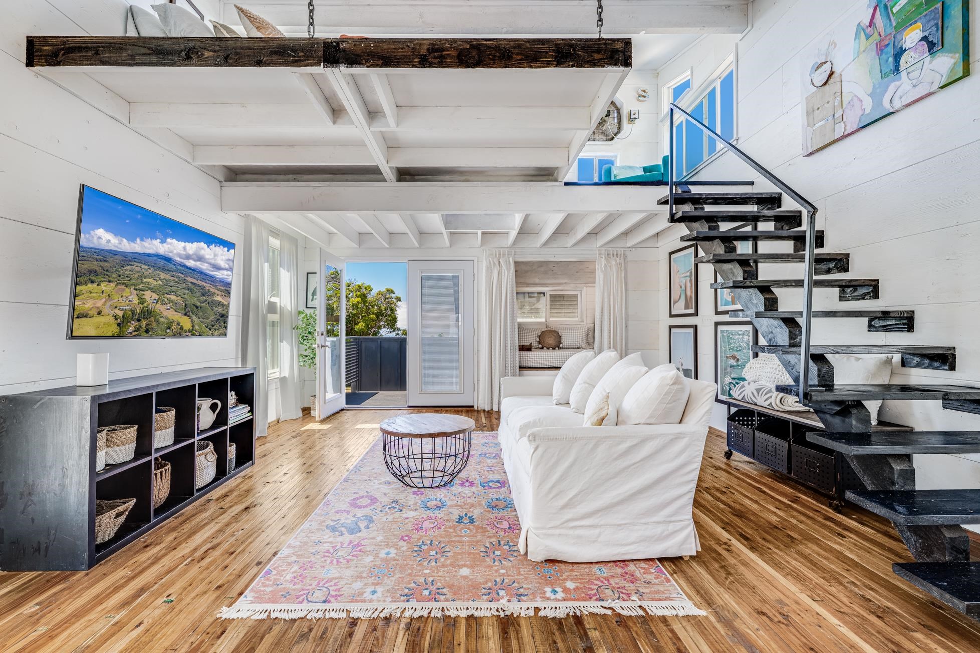 796 Awalau Road Haiku, HI 96708 - Photo 44 of 50 a living room with furniture and a book shelf