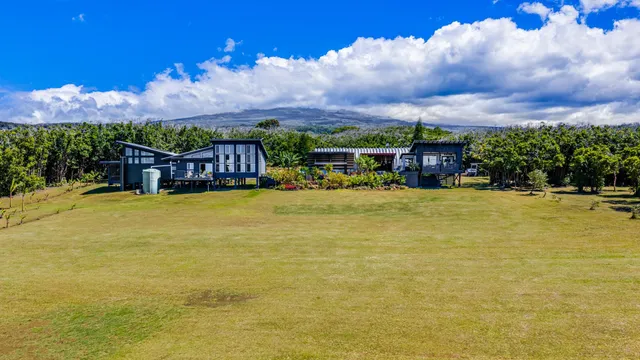 an aerial view of a house with a yard
