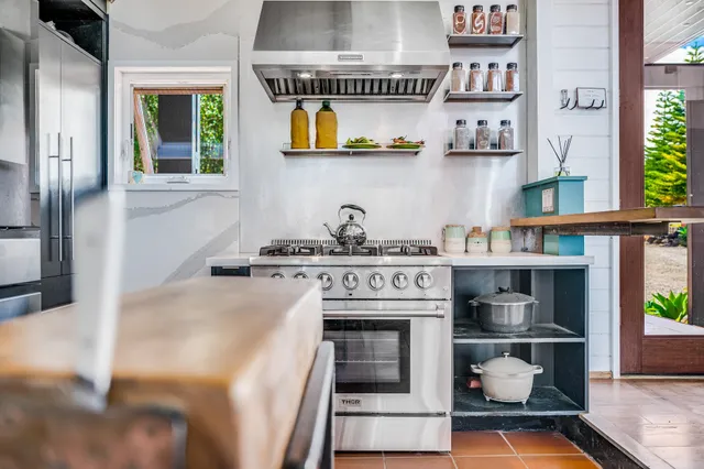a kitchen with stainless steel appliances granite countertop a stove and a cabinets