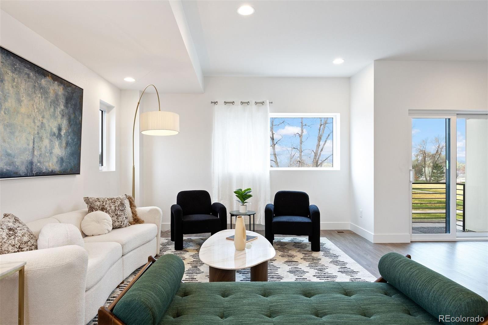 5189 Carr Street Arvada, CO 80002 - Photo 11 of 30 a living room with furniture and wooden floor