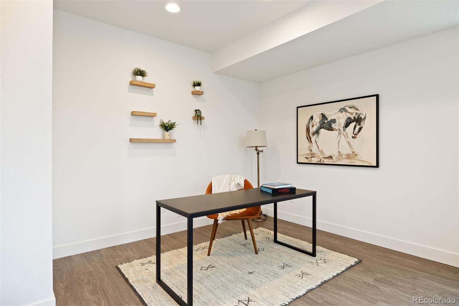 5189 Carr Street Arvada, CO 80002 - Photo 3 of 30 a view of a workspace with furniture and wooden floor
