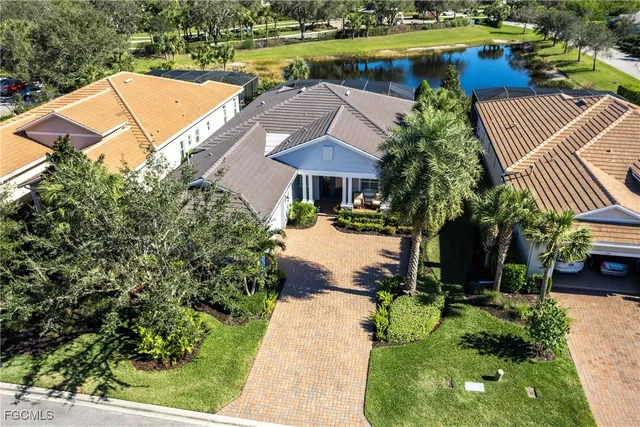 a view of a swimming pool with a patio and a yard