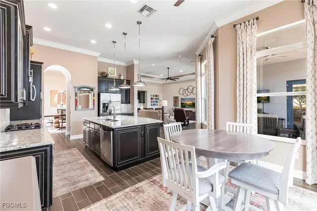 a kitchen with stainless steel appliances granite countertop a stove oven and a refrigerator