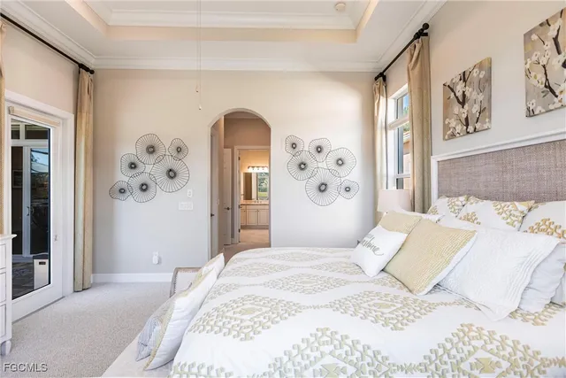 a bedroom with a large bed and painting on the wall