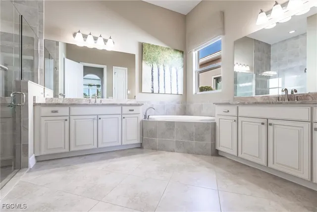 a spacious bathroom with a sink vanity and mirror