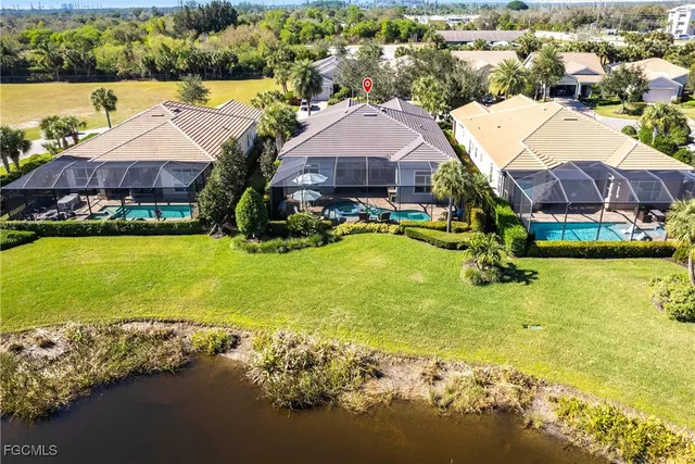 a aerial view of a house with swimming pool and outdoor seating