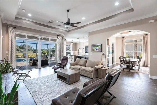 a living room with patio furniture and a large window