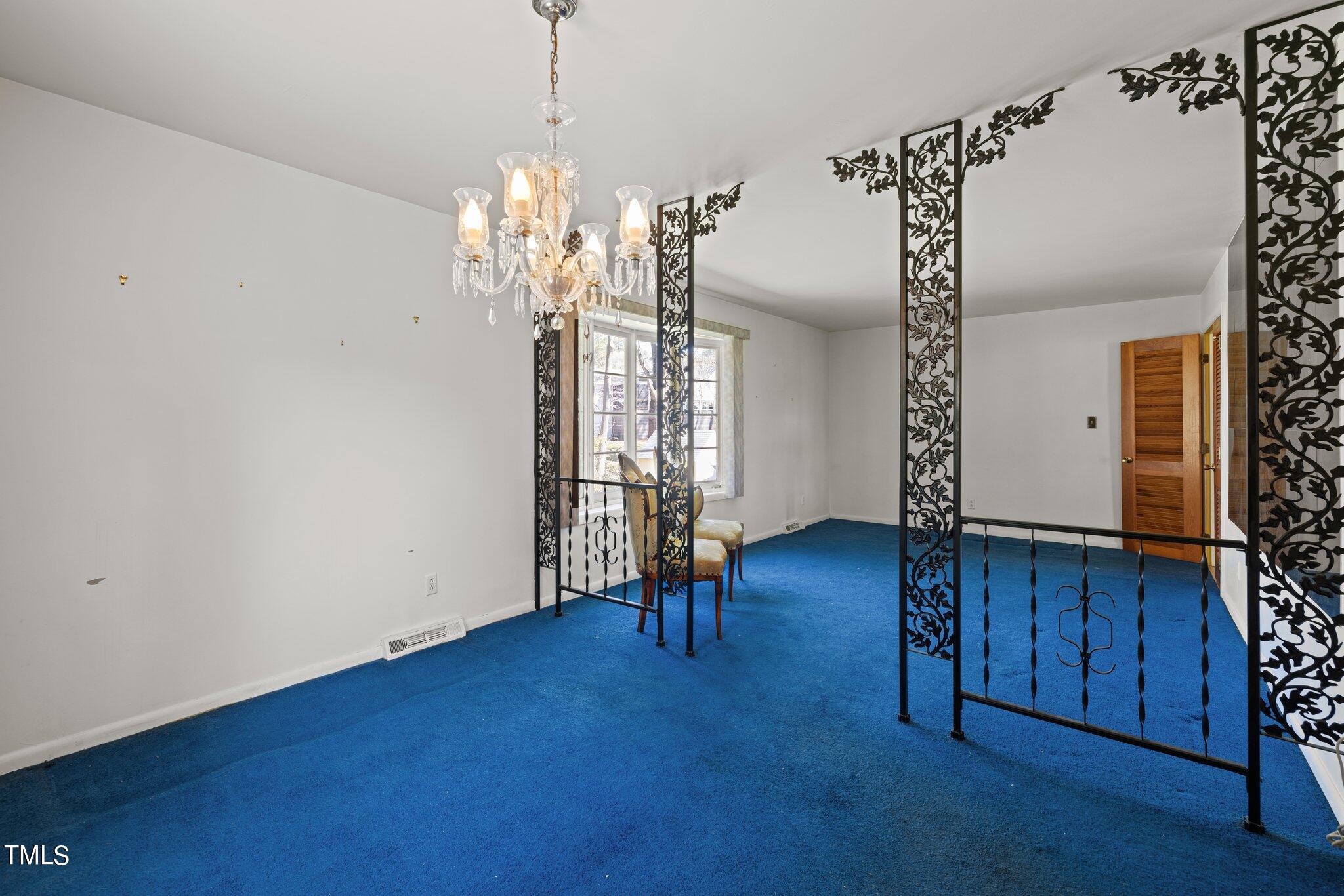 4705 Latimer Road Raleigh, NC 27609 - Photo 16 of 51 a view of a livingroom with wooden floor and a chandelier