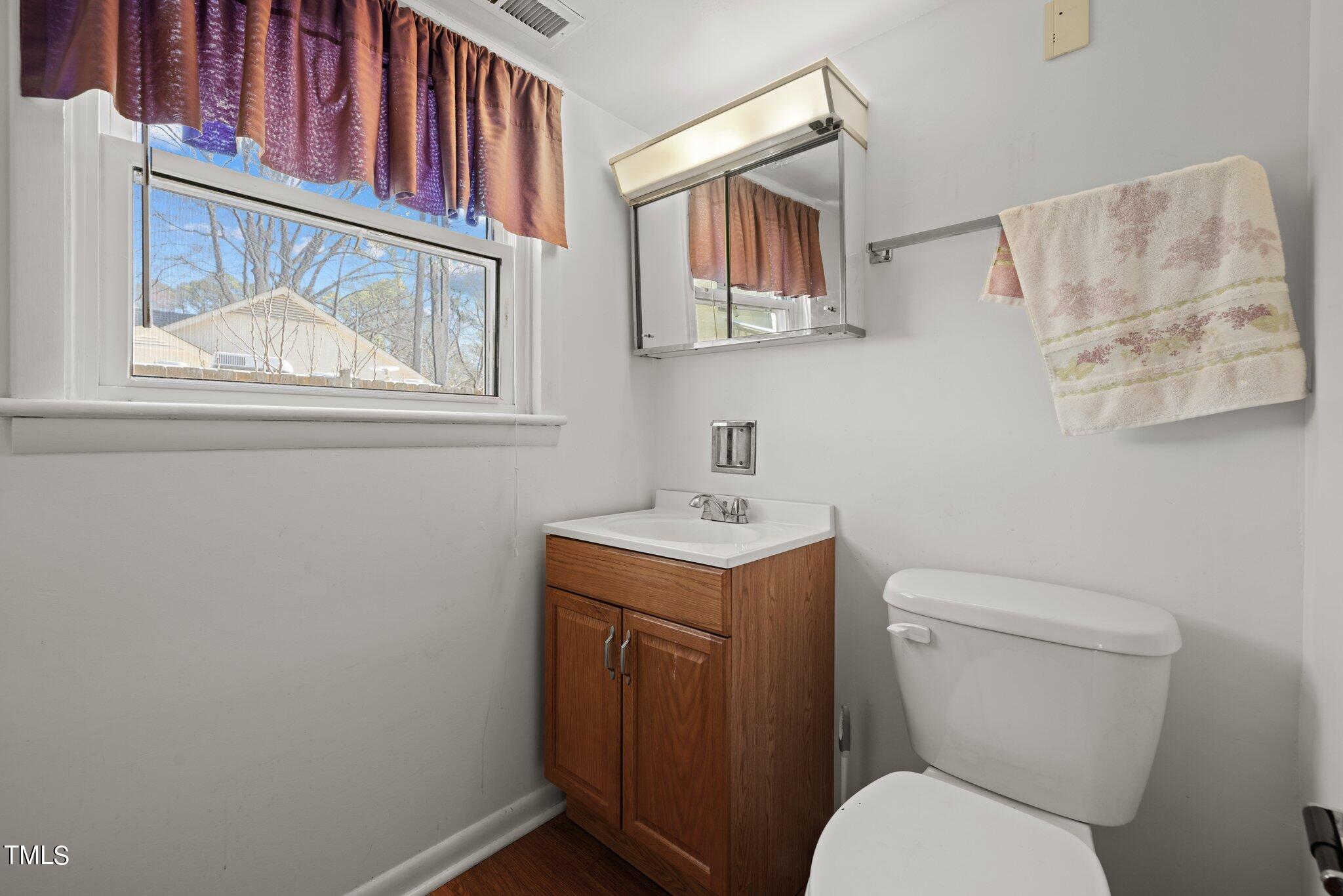 4705 Latimer Road Raleigh, NC 27609 - Photo 36 of 51 a white toilet sitting next to a bathroom sink