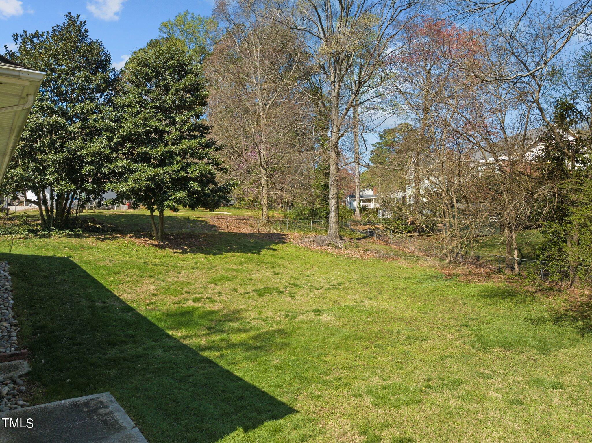 4705 Latimer Road Raleigh, NC 27609 - Photo 45 of 51 a backyard of a house with lots of green space