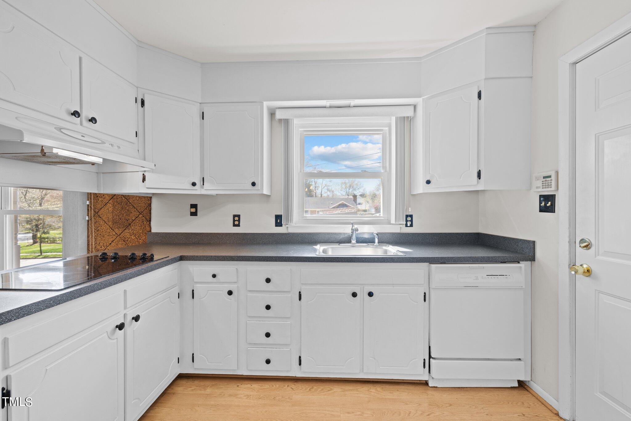 4705 Latimer Road Raleigh, NC 27609 - Photo 9 of 51 a kitchen with granite countertop white cabinets and white appliances