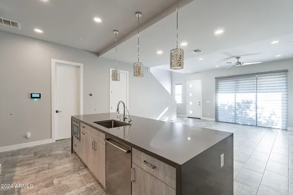 a kitchen with stainless steel appliances granite countertop a sink a stove and a refrigerator