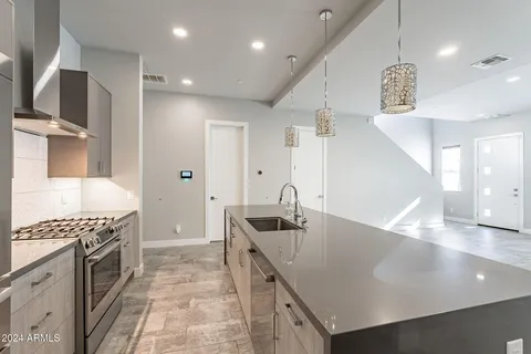 a kitchen with a sink and a refrigerator