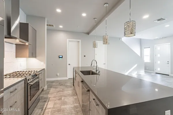 a kitchen with a sink and a refrigerator